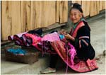 016. A woman sewing in a Red Hmong village